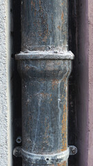 Cast iron detail of a downpipe rainwater in a street