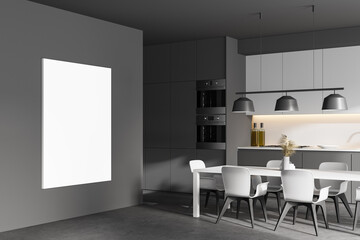 Gray and white kitchen corner with table and poster