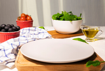 Healthy Vegetarian Salad on the Plate with Spinach, Tomatoes and Olives dressed with Olive Oil. Dieting Green Food. Healthy Lunch or Dinner. Preparing salad Step 1.