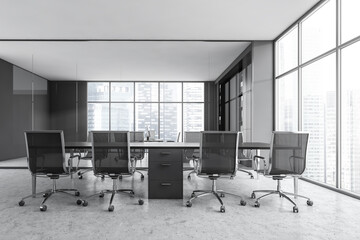 Grey conference room with armchairs, modern furniture and window