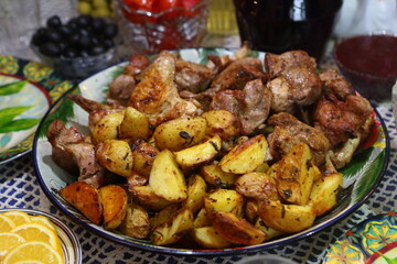Kebab with potatoes on a plate