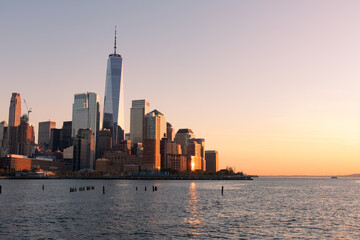Fototapeta premium Beautiful Lower Manhattan New York City Skyline along the Hudson River during a Colorful Sunset