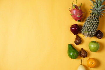 Combination of leaves and fresh fruits. Simple and elegant framing of fruit and leaves. Wallpaper that attracts the eye, commonly used for design templates, mockups and invitations. Jungle Fruits.