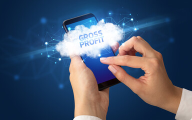 Female hand touching smartphone with GROSS PROFIT inscription, cloud business concept