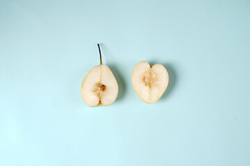 Fresh pear set, isolated whole and sliced. From the top view as a package design element. The pear placement concept is combined with a plain background, commonly used for design templates and mockups