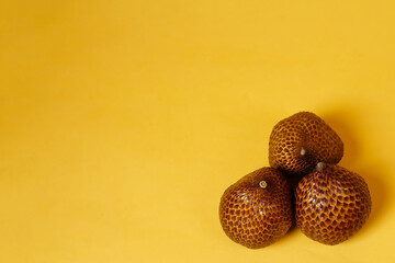 Thorny palm fruits (salak) is a scaly fruit like a snake, usually eaten directly or made into candied fruit. Salak grows a lot in tropical areas, especially in Indonesia. Fruits Wallpaper for design.