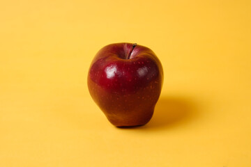 Shiny fresh apples. From the side view. The concept of placing fresh apples is combined with a yellow background, commonly used for design templates and mockups. Beautiful shape of an apple.