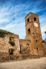Fototapeta na wymiar Square and tower with the clock in the ghost town of Celleno (Italy)