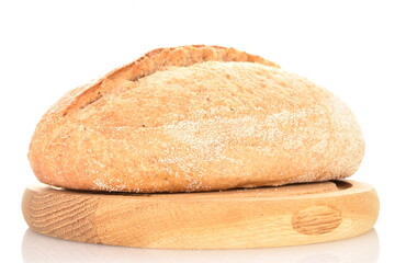 One fresh loaf without yeast with bran cereal on a round wooden tray, close-up, isolated on white.