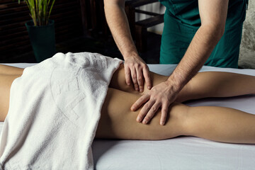 Fototapeta na wymiar Foot calf massage. Lymphatic drainage massage