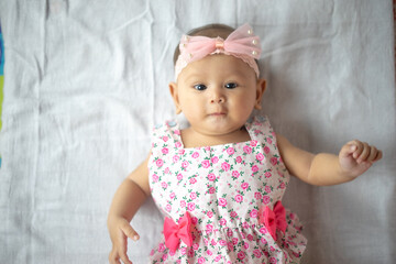 Healthy 3-4 Month Old Baby Girl looking up at Camera with multiple expressions