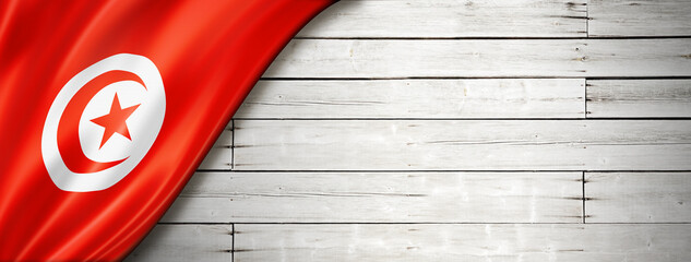 Tunisian flag on old white wall banner