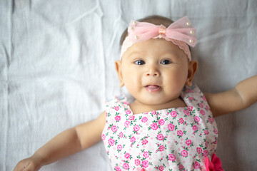 Healthy 3-4 Month Old Baby Girl looking up at Camera with multiple expressions