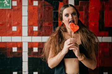 Young agressive clown girl with sweet