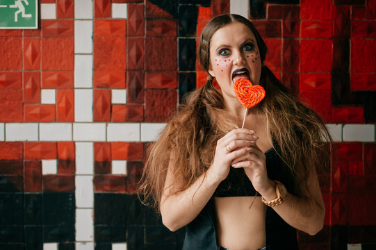 Young agressive clown girl with sweet