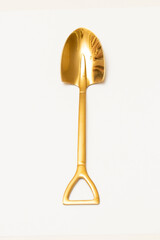 Top view of golden spoon shovel isolated white background.