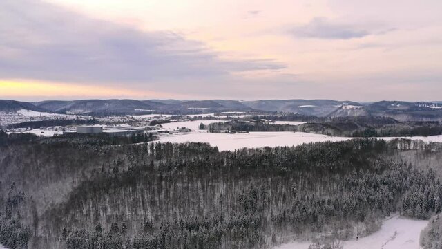 Winter landscape - Panning shot with the llok into the sunny, cloudy sky over a snowy landscape