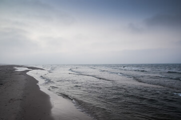 Empty quiet beach and Baltic Sea, Slowinski National Park, Leba. Fog in the background