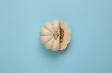 Cut white mini pumpkin on a blue background