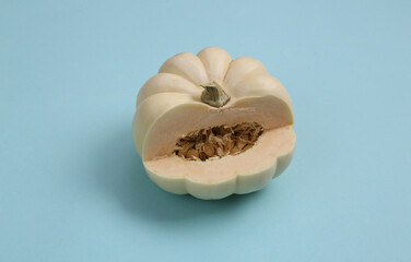 Cut white mini pumpkin on a blue background