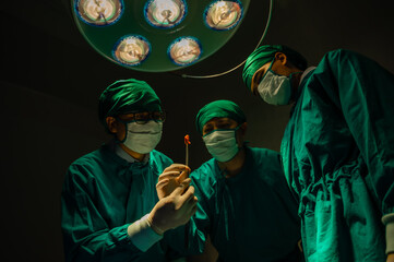 Fototapeta premium Group of asian doctor expert surgeons during a big surgery in surgical room.