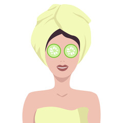 Girl with a towel on her head with cucumbers in her eyes