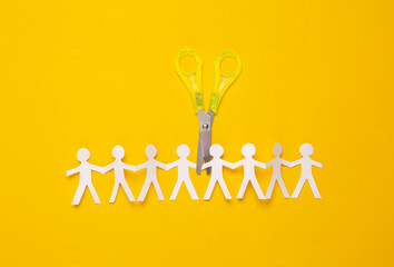 Paper cut chain of people with scissors on yellow background
