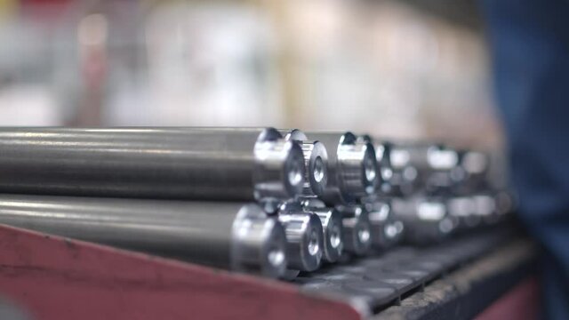 Panning shot of a batch of cnc finished tubes