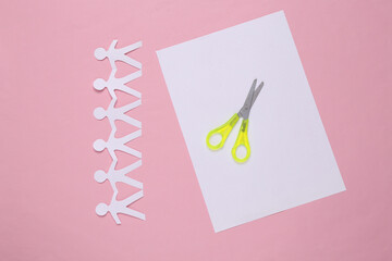 Paper cut chain of people with scissors on pink background