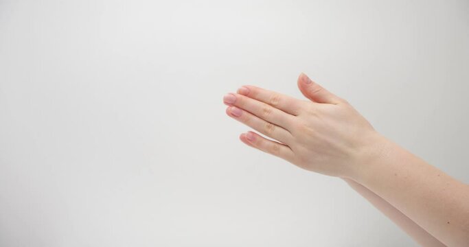 Applause with female hands on a light background