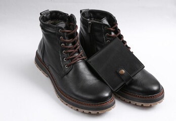 Men's leather boots and wallet on a white background