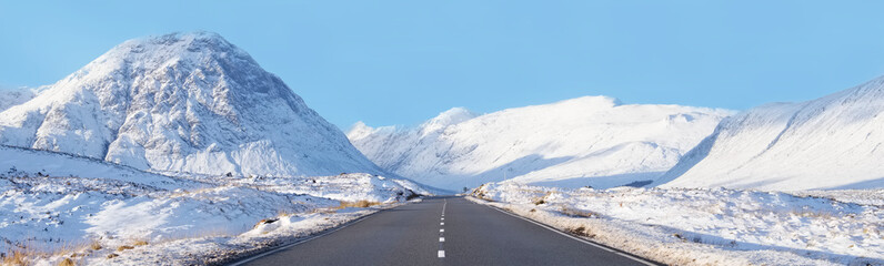 Buachaille Etive Mor and empty road covered in snow during winter - obrazy, fototapety, plakaty