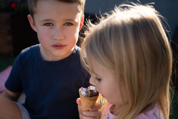 Two kids eating an ice cream