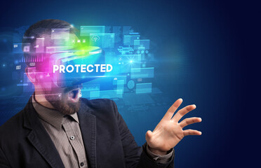 Businessman looking through Virtual Reality glasses with PROTECTED inscription, innovative security concept