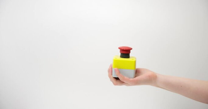 The female hand presses the red button on a light background