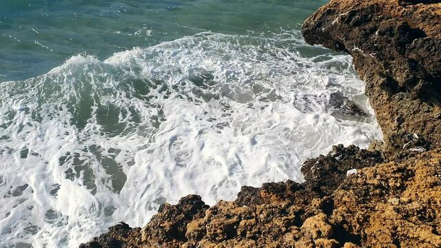Waves crushing on the rocks in small cove in Salou