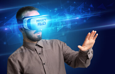 Businessman looking through Virtual Reality glasses with PRIVACY POLICY inscription, cyber security concept