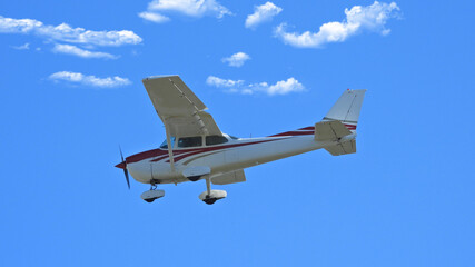 Zoom photo of small propeller airplane landing to small airport