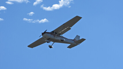 Fototapeta na wymiar Zoom photo of small propeller airplane landing to small airport