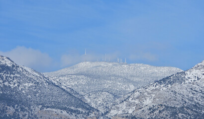 Fototapeta na wymiar Zoom photo of beautiful mountain of Parnitha covered in snow, Athens, Attica, Greece