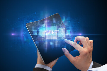 Businessman holding a foldable smartphone with ASP.NET inscription, new technology concept