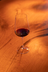 Glass of red wine on a wooden table