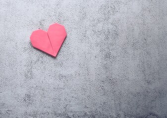 Origami paper heart on natural background. Valentine's Day concept