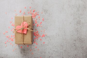 Happy Valentine's Day photography with gift box and paper origami heart on wooden background....