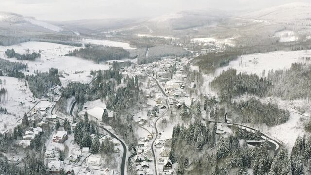 Winter in the Harz national park. Drone aerial footage of the idyllic village Schierke at the bottom of the Brocken Mountain in Germany, Europe.