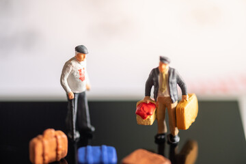 Miniature Tourists standing on the calendar with bags