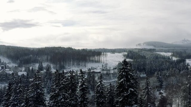 Winter in the Harz national park. Drone aerial footage of the idyllic village Schierke at the bottom of the Brocken Mountain in Germany, Europe.