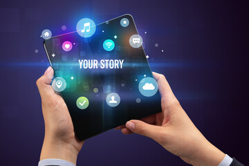 Businessman holding a foldable smartphone with YOUR STORY inscription, social media concept