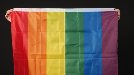 LGBTQ flag or Lesbian Gay Bi sexsual Transgender Queer or homosexsual pride Rainbow flag on black background. Represent hand symbol of freedom, peace, equality and love. LGBTQ concept