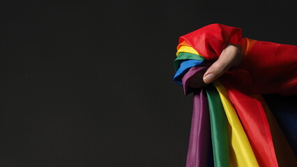 LGBTQ flag or Lesbian Gay Bi sexsual Transgender Queer or homosexsual pride Rainbow flag on black background. Represent hand symbol of freedom, peace, equality and love. LGBTQ concept